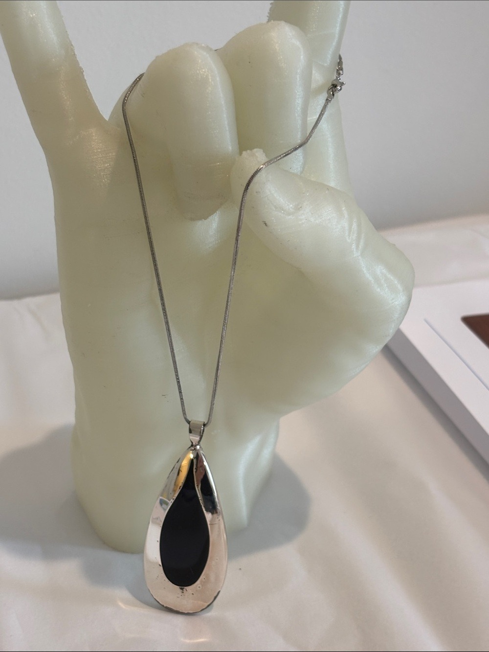 Silver tear drop necklace black inset 16” chain NSD marking on back 1.3oz